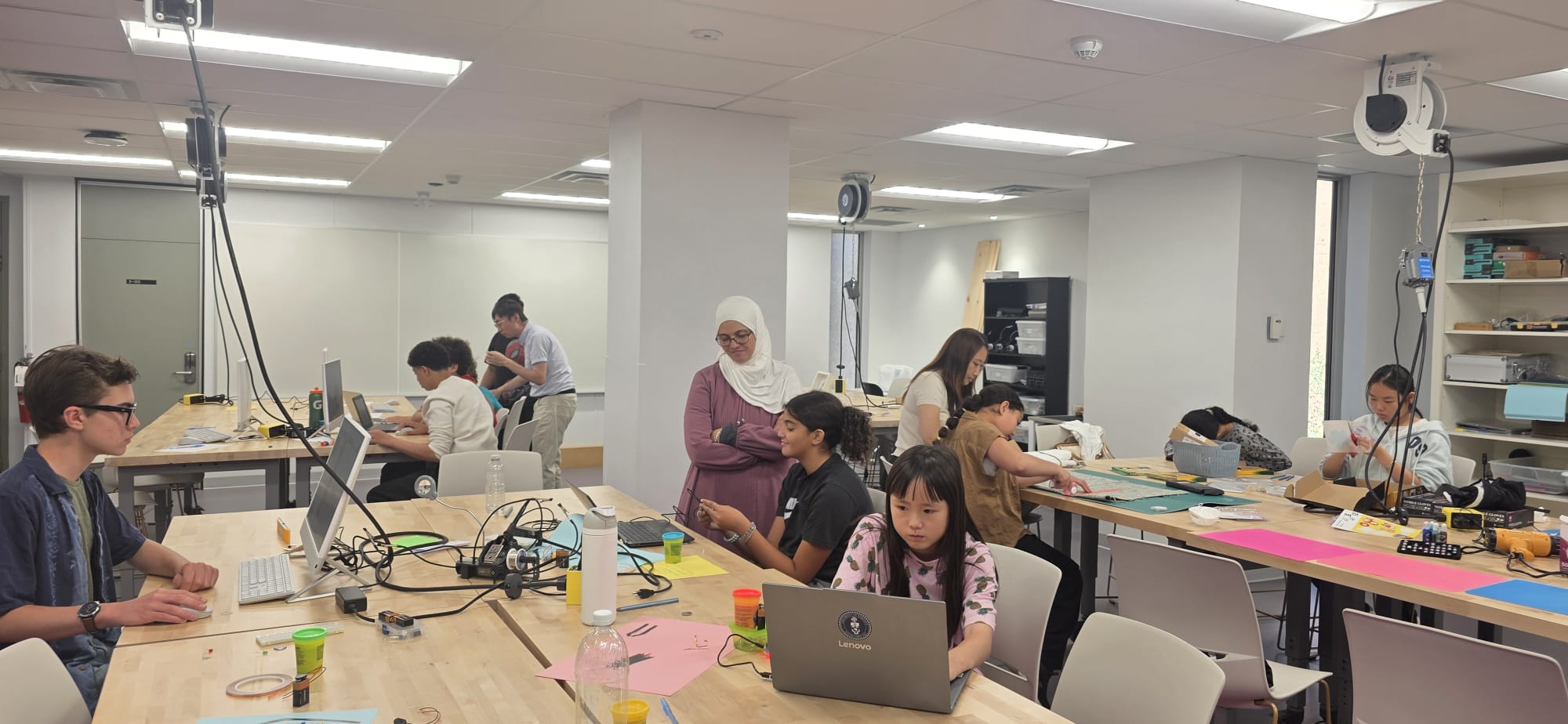 Students working together across the makerspace's different stations